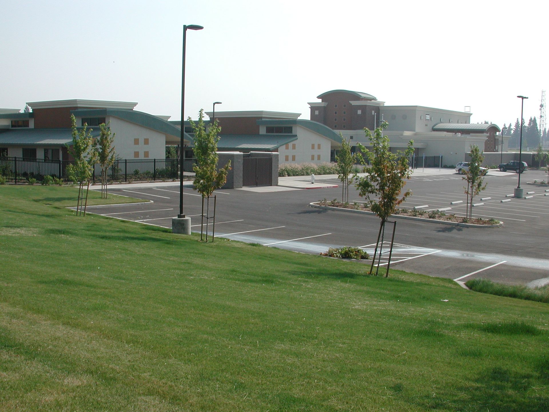 a parking lot with a large building in the background