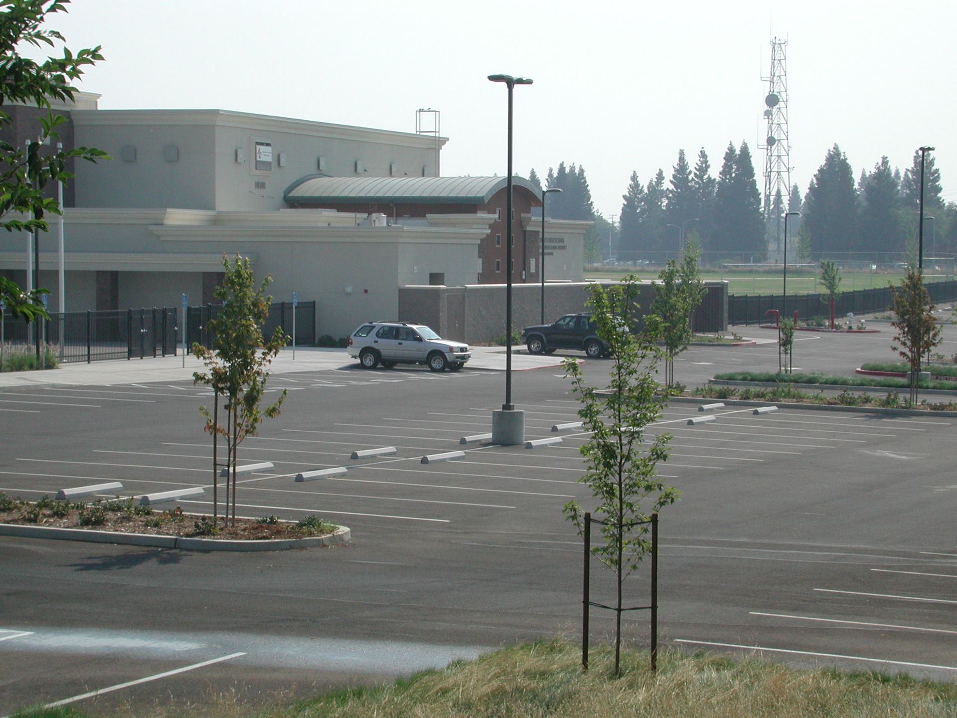 a car is parked in a parking lot in front of a building