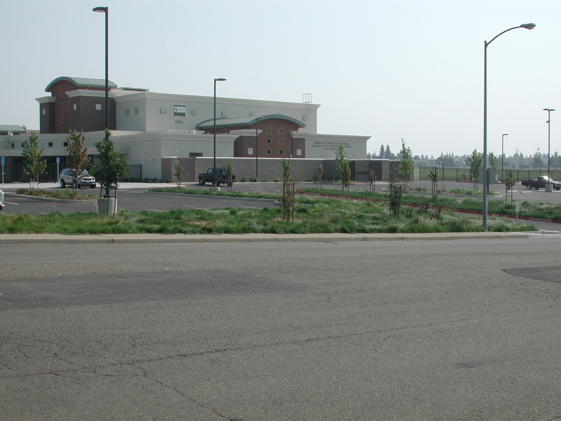 a parking lot with a large building in the background
