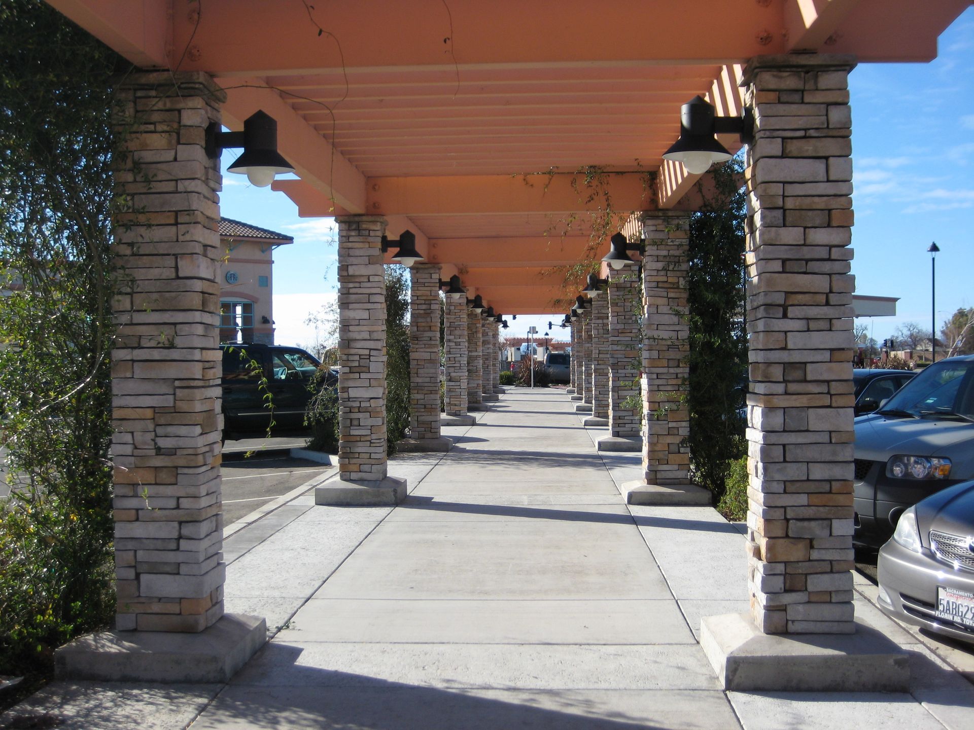 a row of stone pillars are lined up in a parking lot