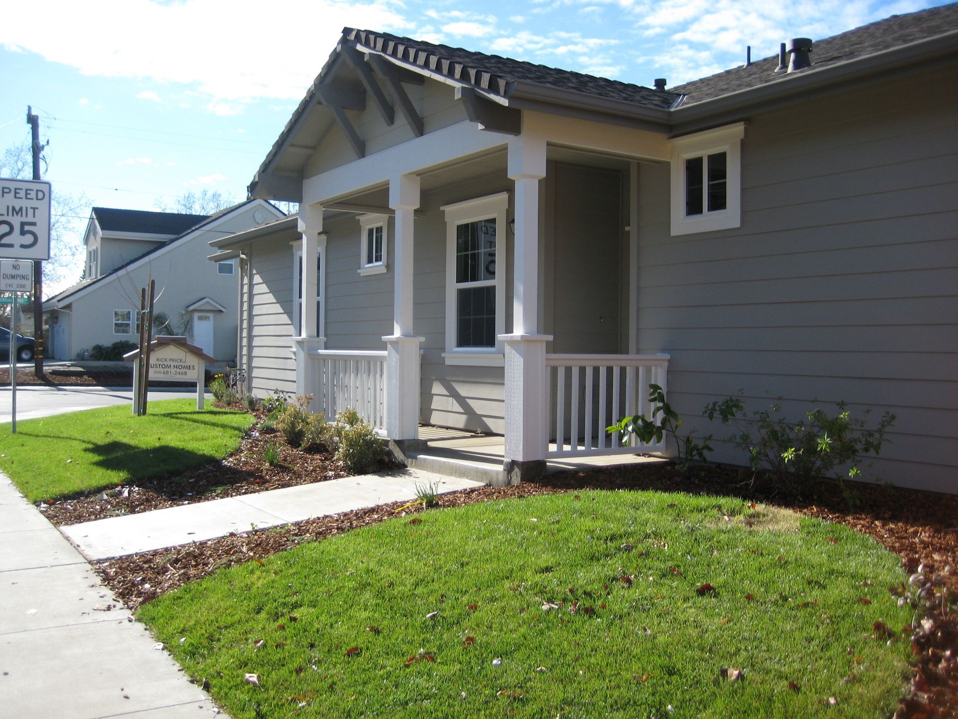 a house with a porch and a sign that says speed limit 25