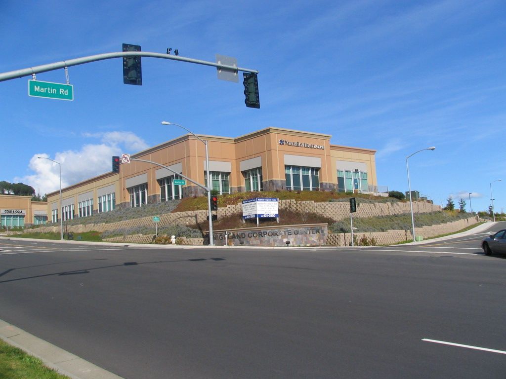 a large building with a green sign that says main st.