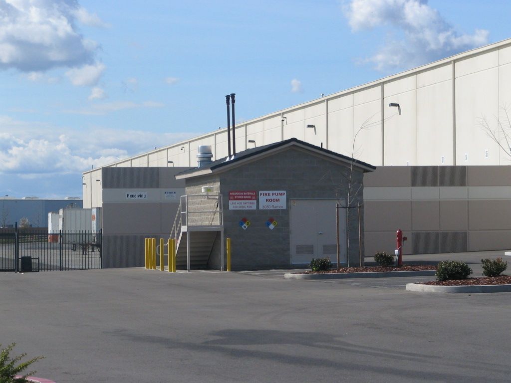 a large building with a small building in front of it