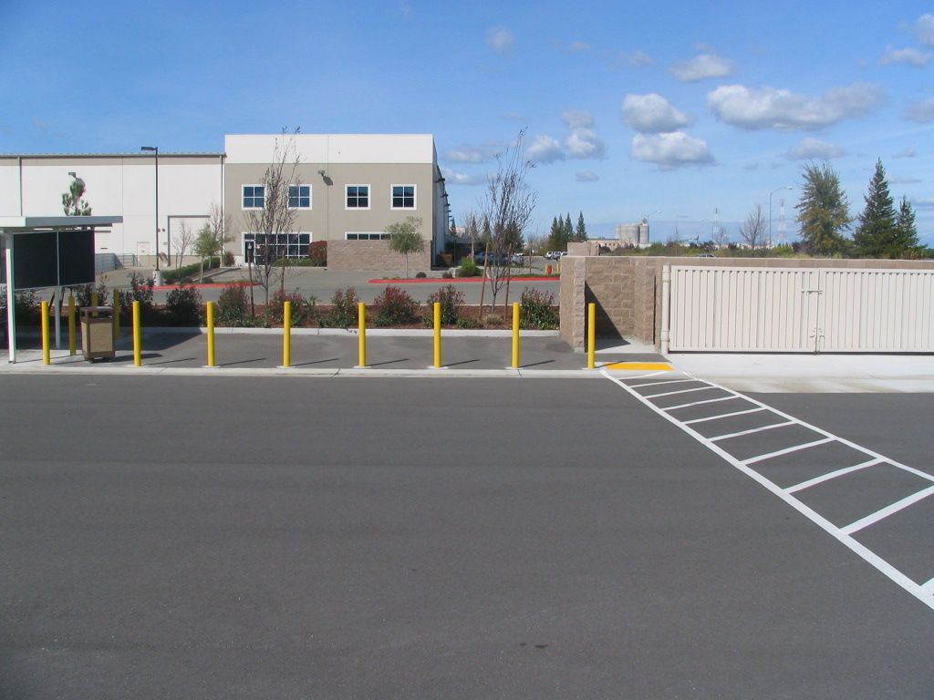 a parking lot with a white building in the background