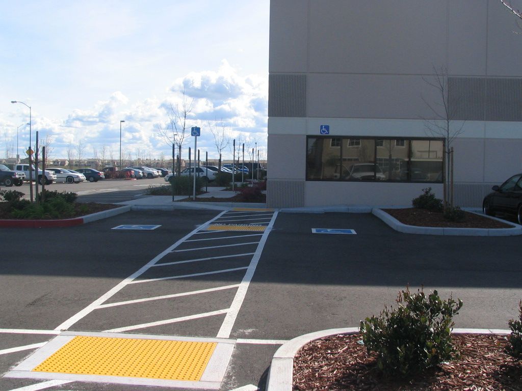 a parking lot with a handicapped parking spot in front of a building