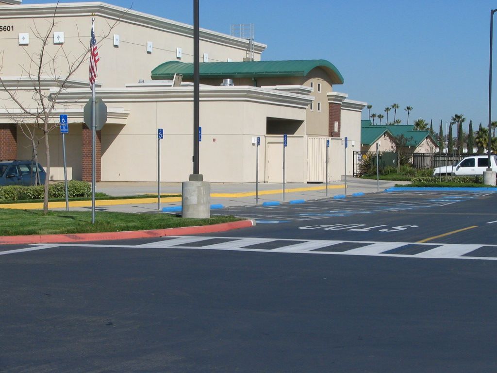 a parking lot in front of a building that has the word office on it