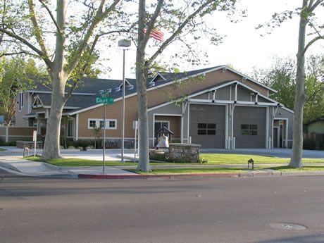 a large building with a green street sign in front of it