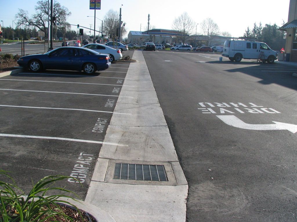 a parking lot with a white arrow pointing to the right