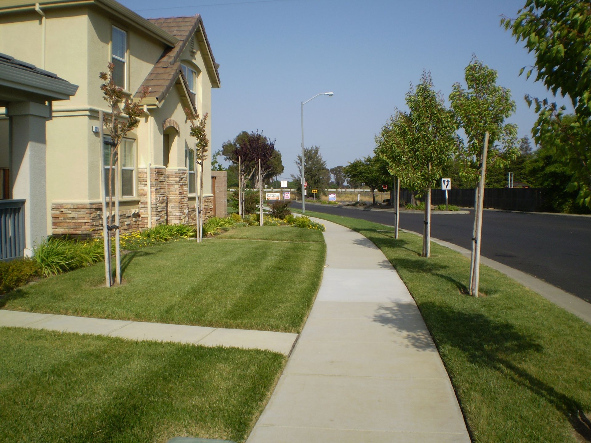 a sidewalk leading to a house in a residential area