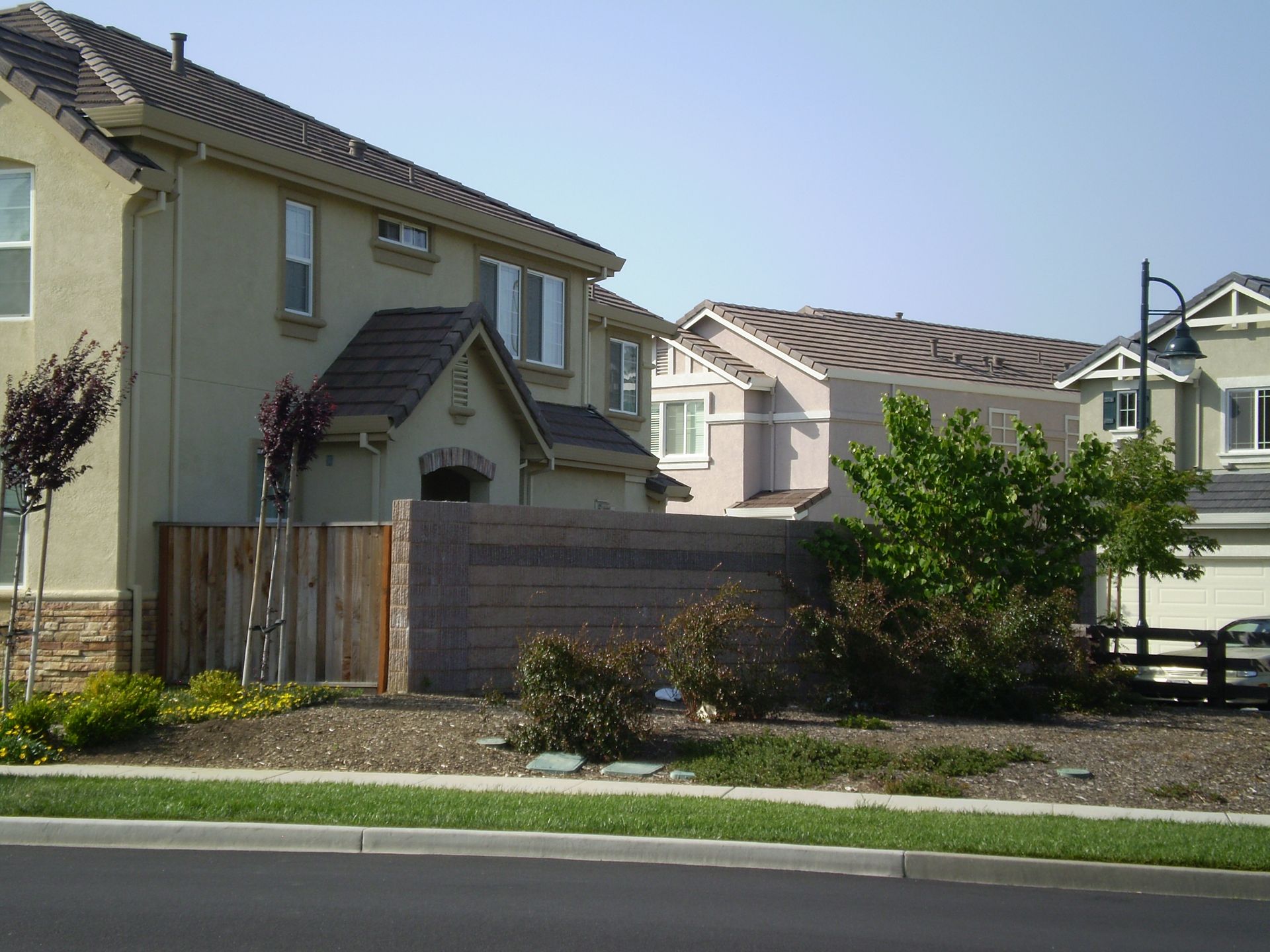 a house with a wooden fence in front of it