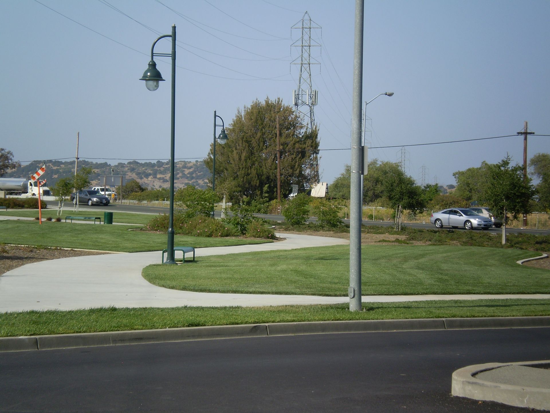 a car is parked on the side of the road next to a street light