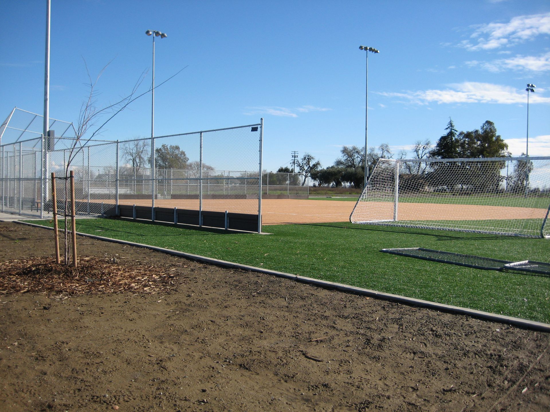 a baseball field with a fence surrounding it