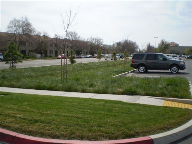 a gray suv is parked in a parking lot