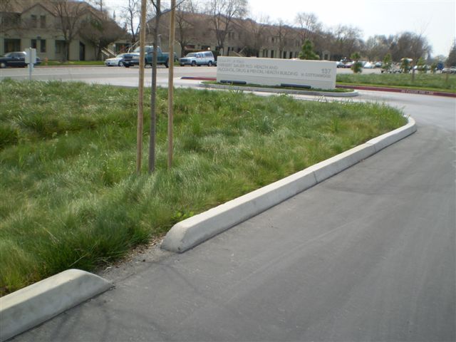 a concrete curb on the side of a road