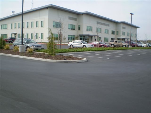 a large building with a lot of cars parked in front of it