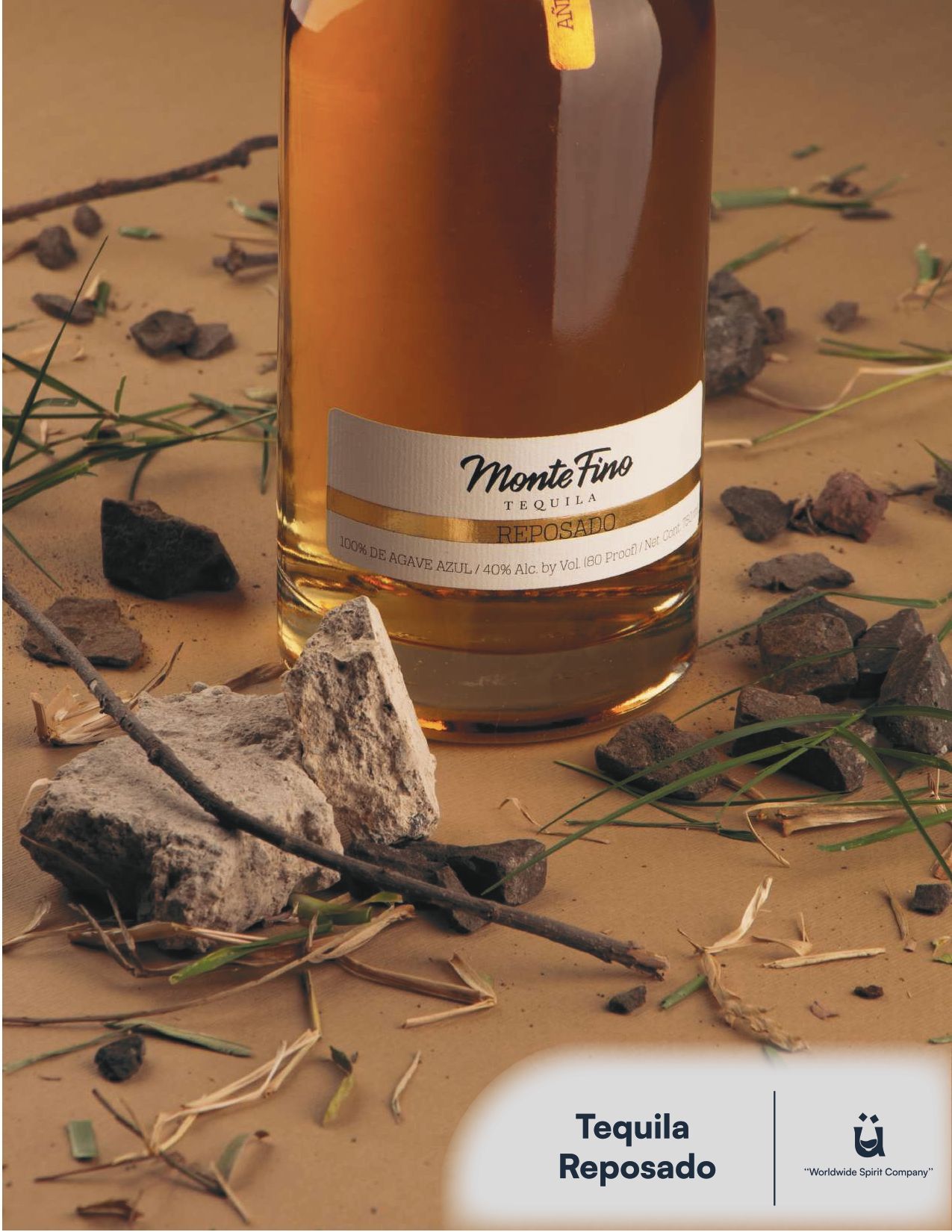Bottle of Monte Fino Reposado tequila on a textured background with rocks, twigs, and grass.