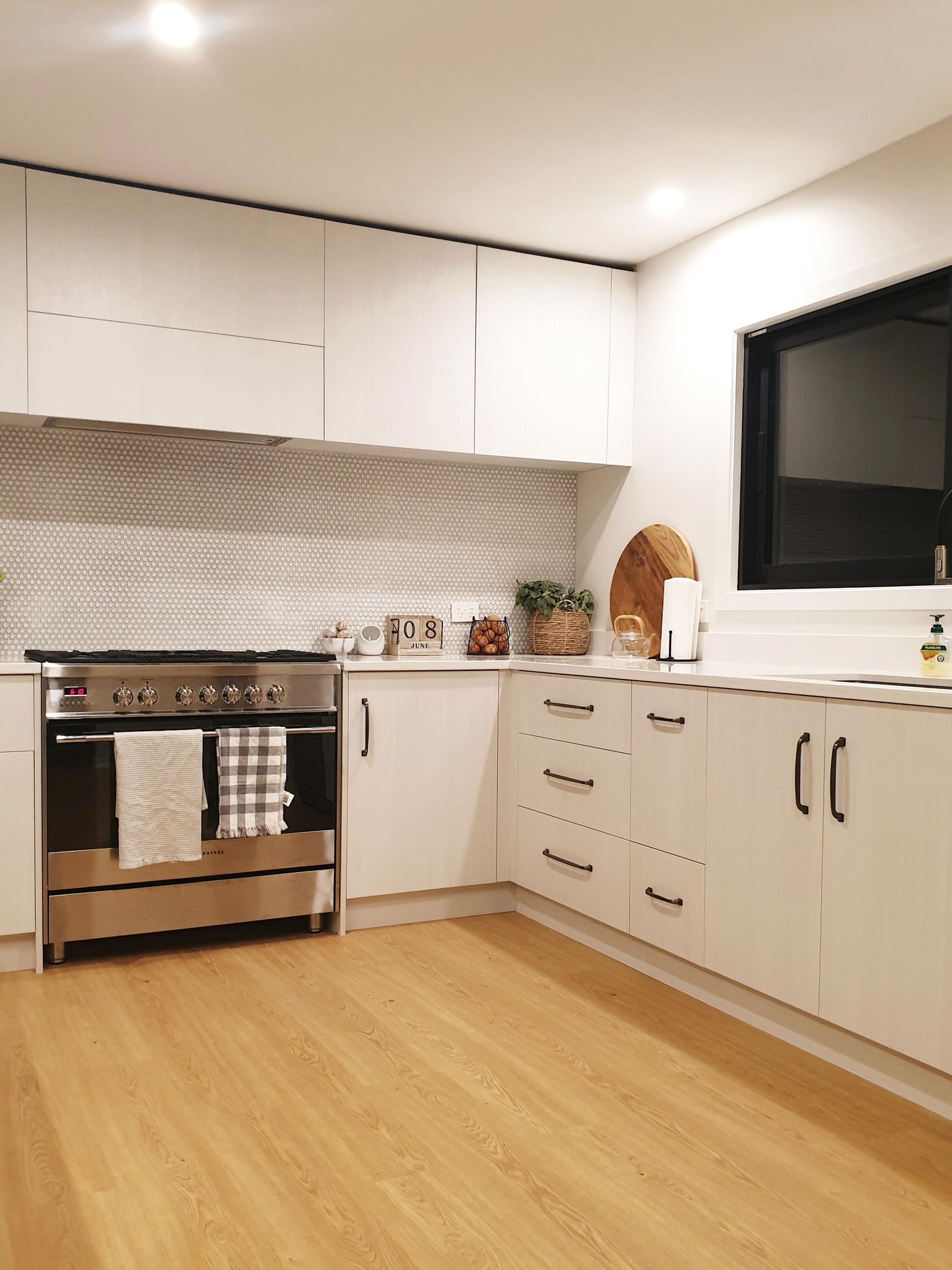 A Kitchen With White Cabinets And Stove — Motueka, NZ — Motueka Joinery Co.