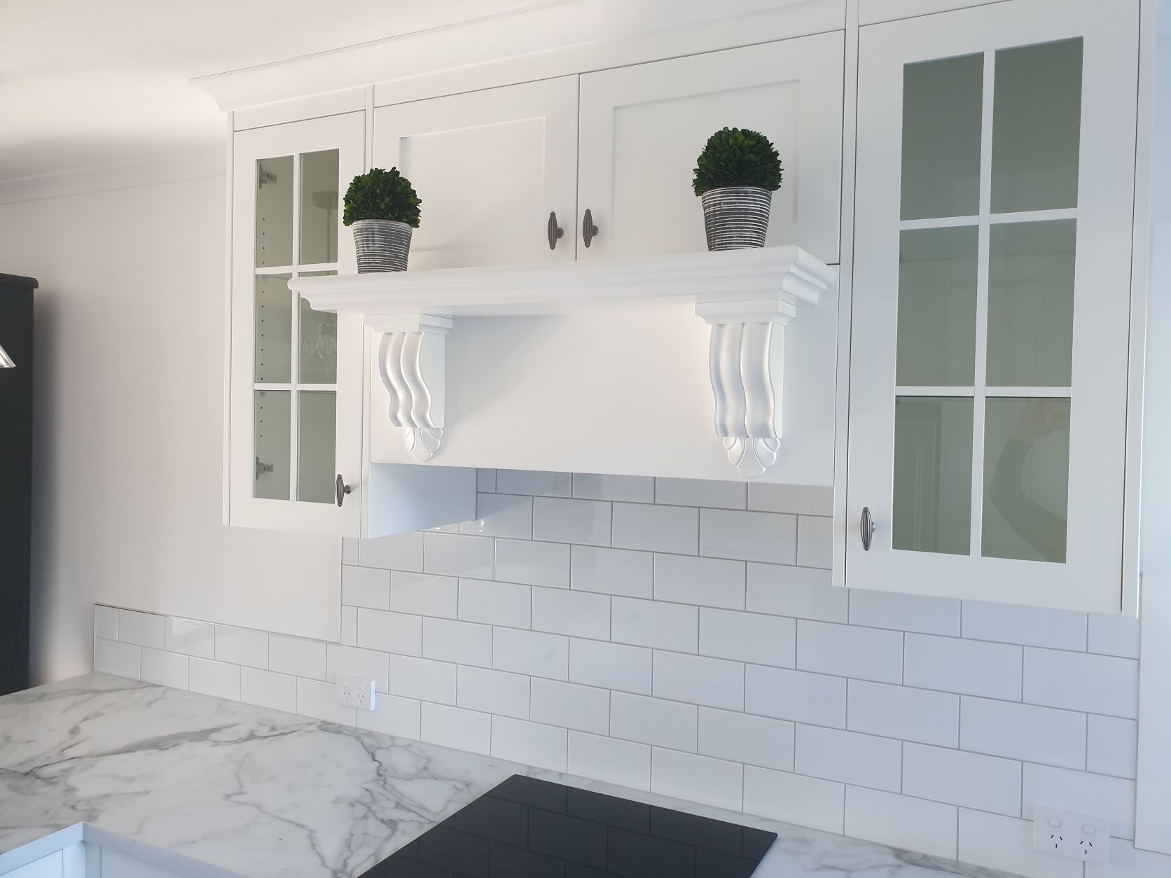 A Kitchen With White Cabinets And A Stove Top Oven — Motueka, NZ — Motueka Joinery Co.