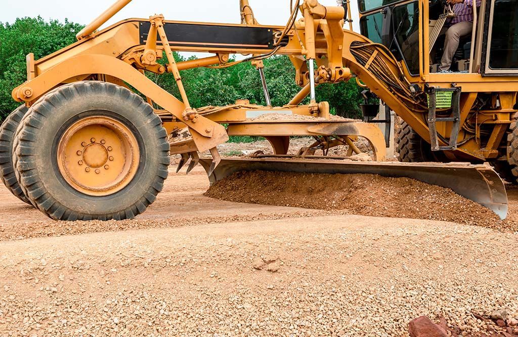 A yellow bulldozer is moving dirt on a construction site.