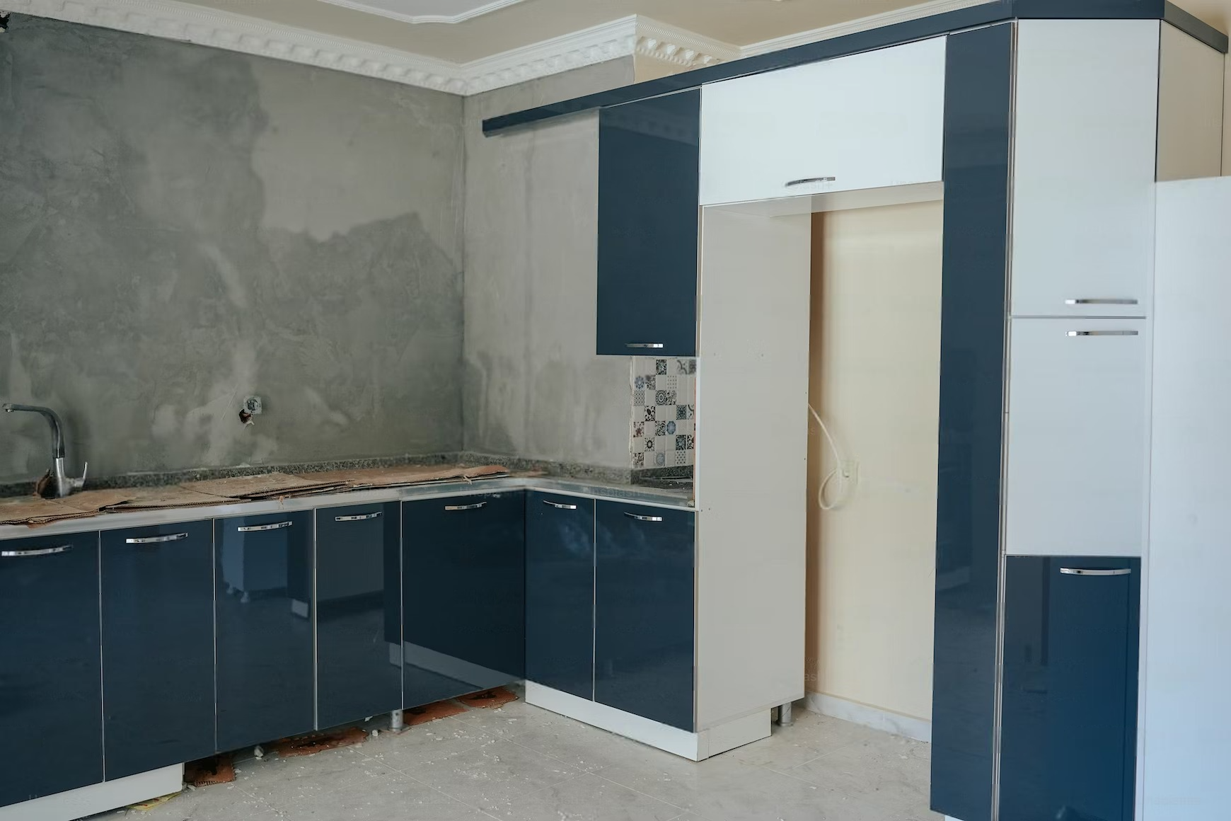 a kitchen with blue and white cabinets.