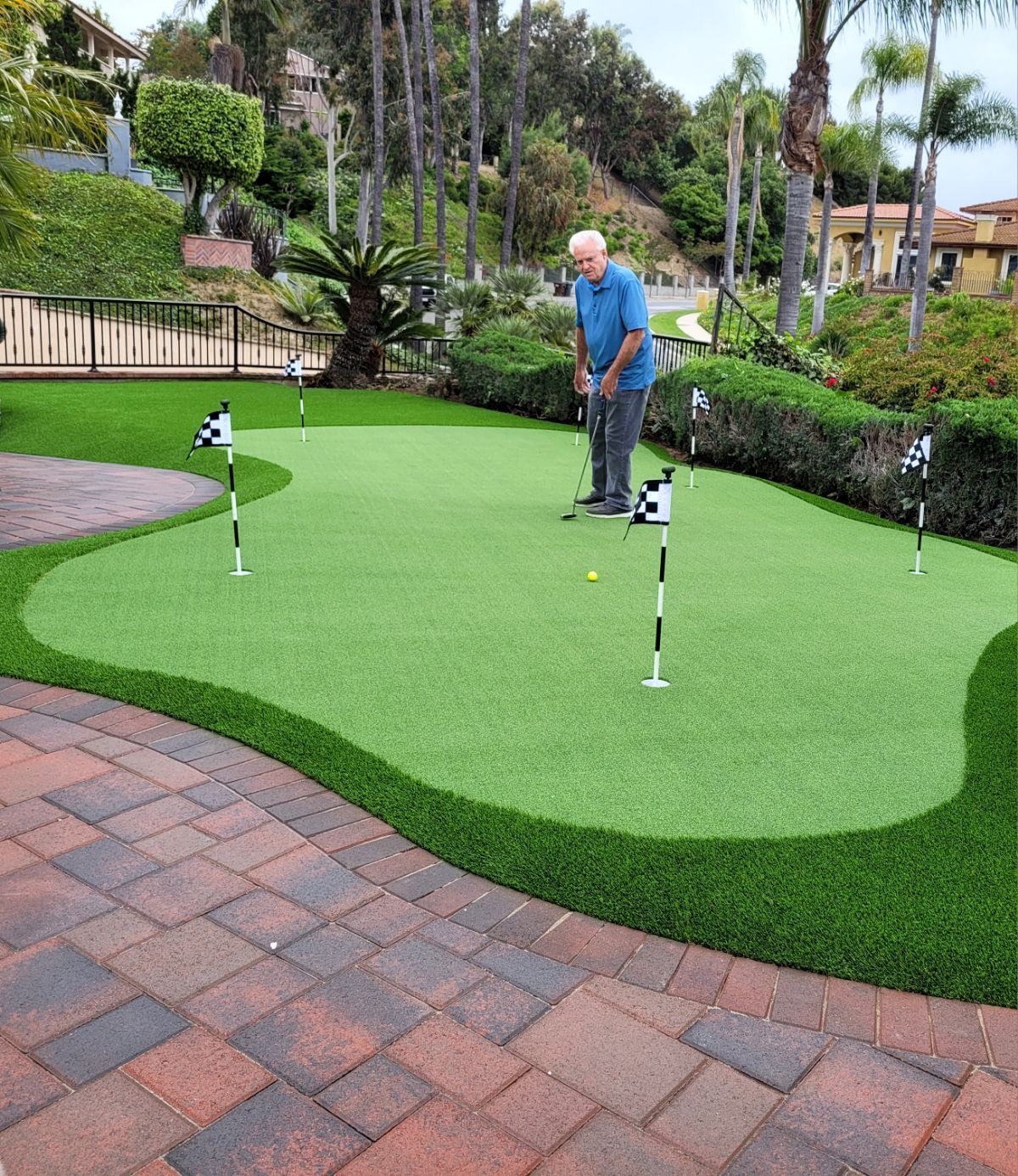 man on synthetic putting green