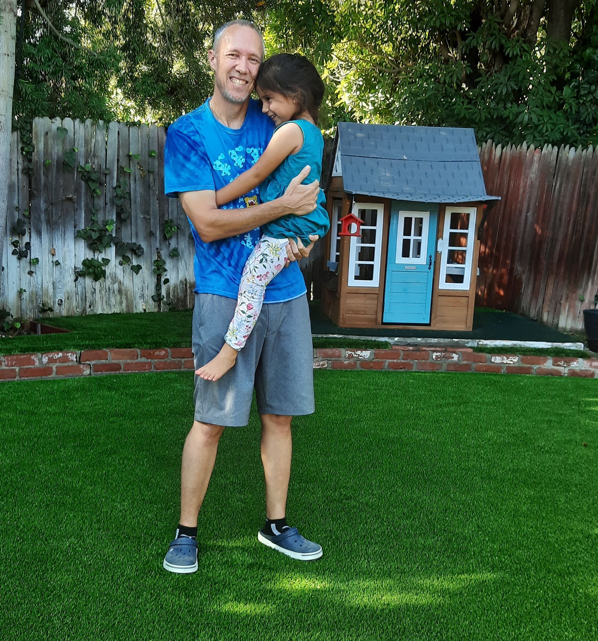 family enjoying artificial pet turf