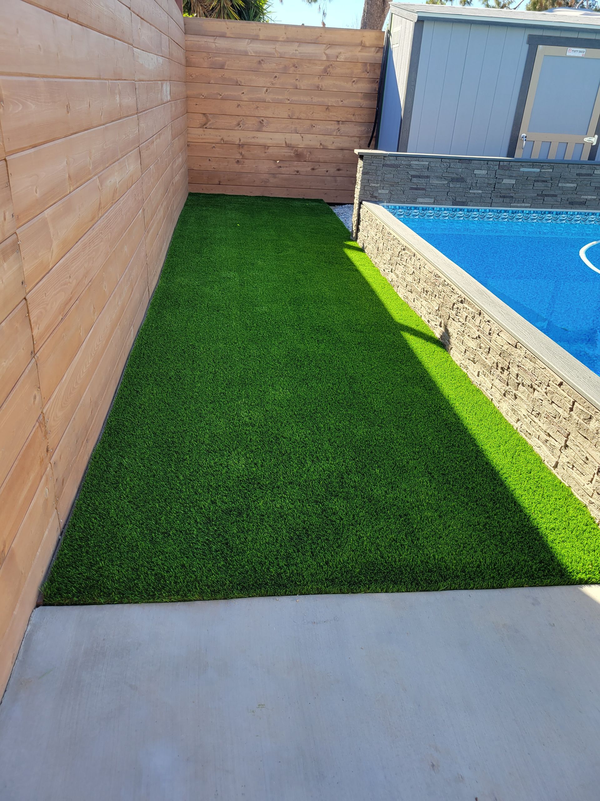artificial grass next to pool