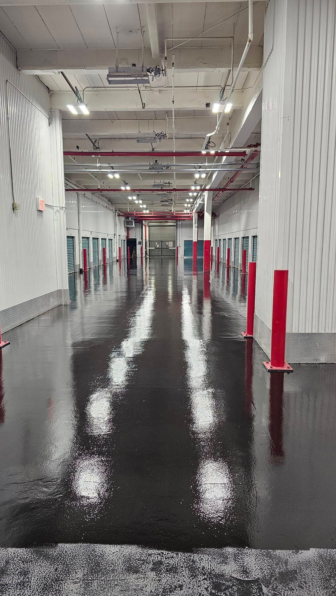 A flooded hallway in a building with a lot of water on the floor.