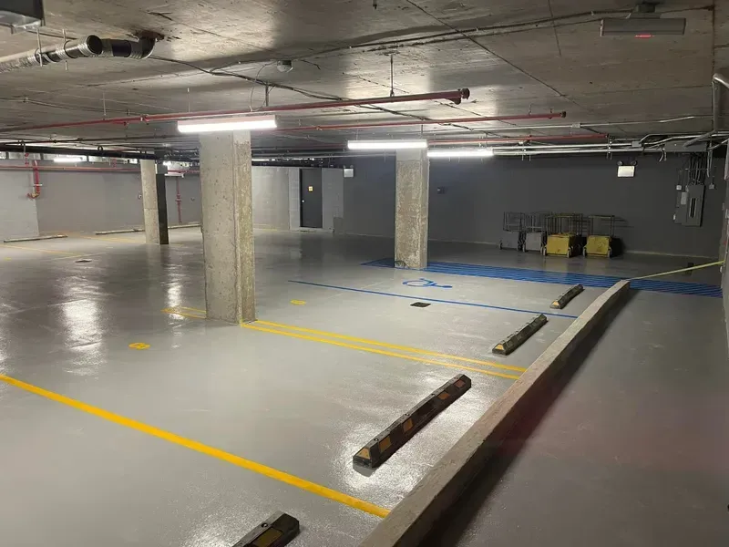An empty parking garage with a yellow line on the floor.