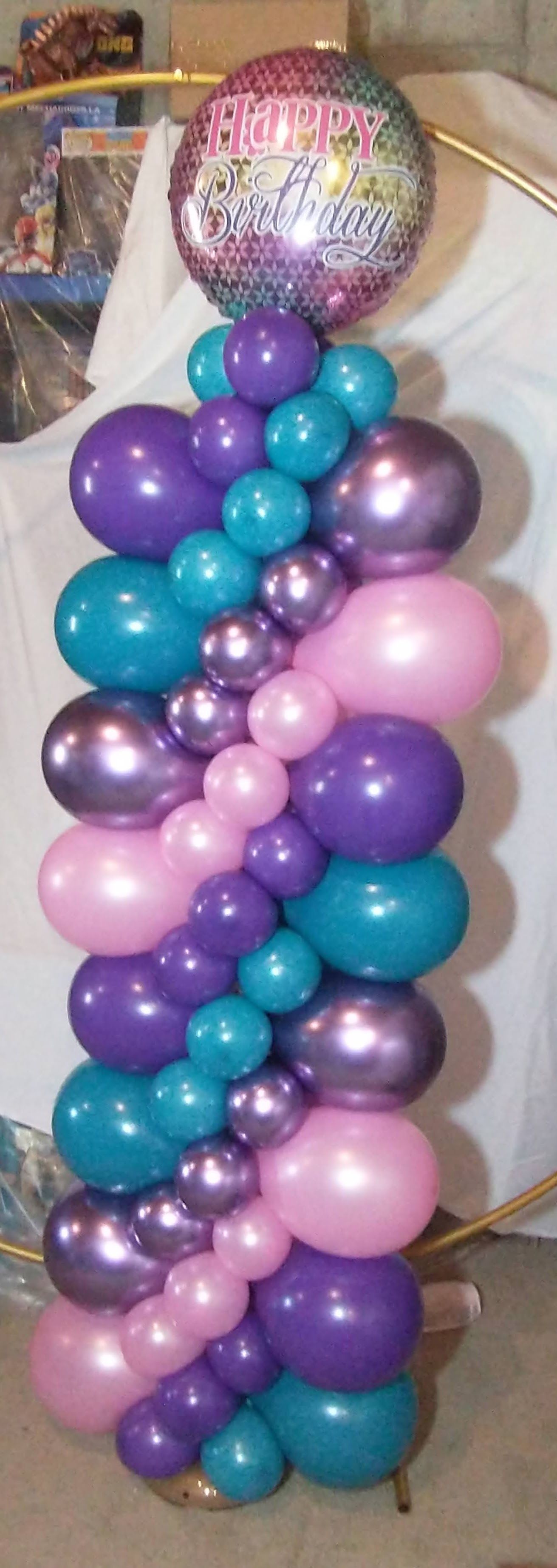 A bunch of balloons are stacked on top of each other on a table.