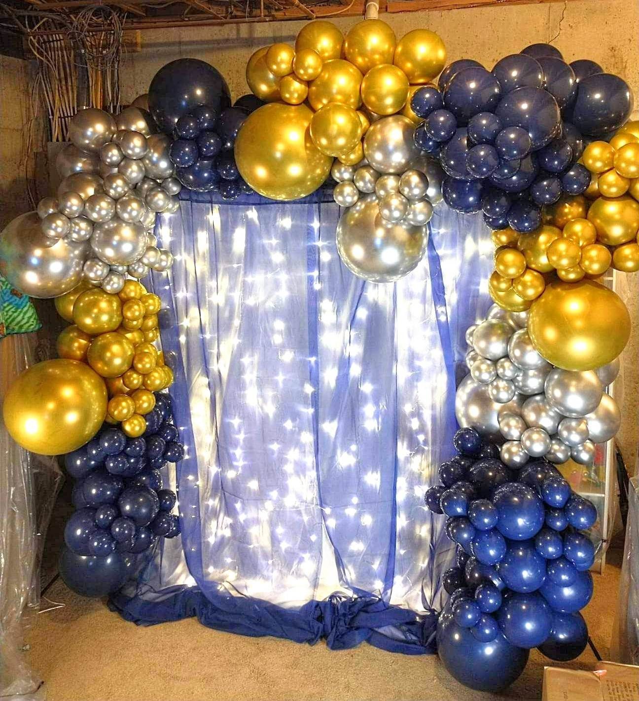 A bunch of balloons are sitting on top of a table in a room.