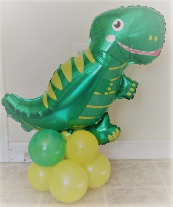 A green and yellow balloon in the shape of a dinosaur