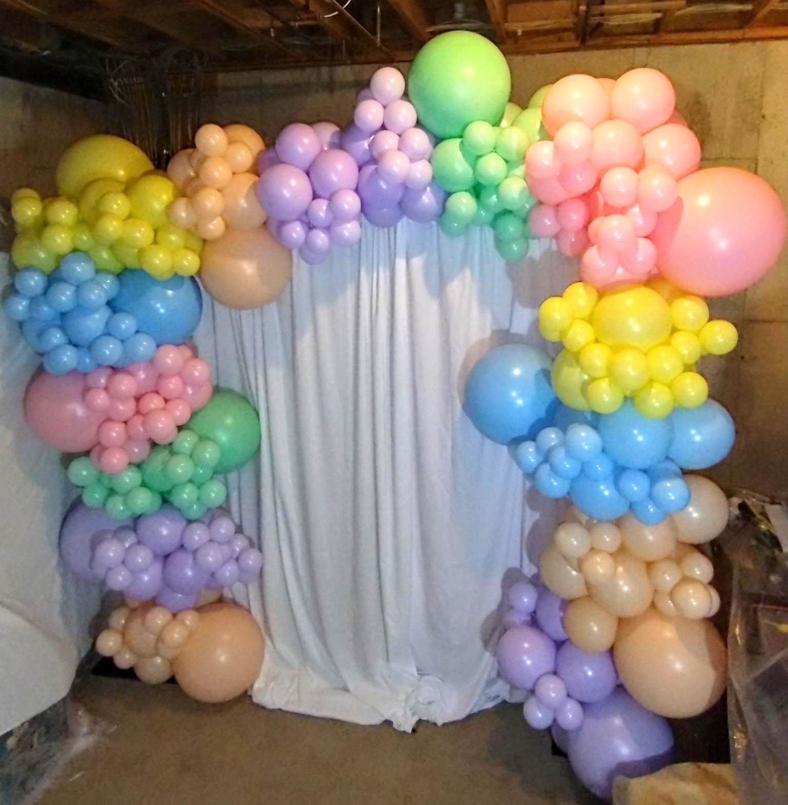 A bunch of colorful balloons on a white cloth