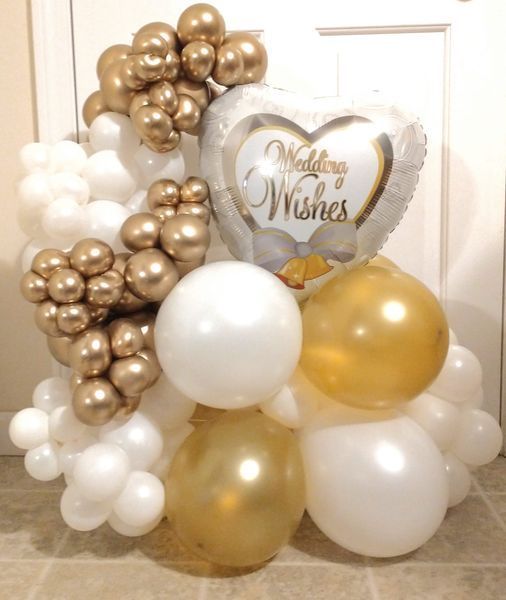 A bunch of balloons with one that says wedding wishes