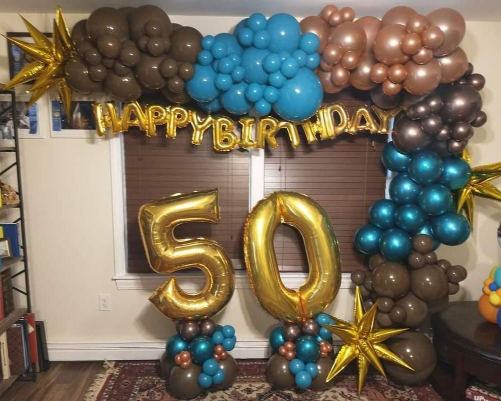 A room decorated with balloons for a 50th birthday.