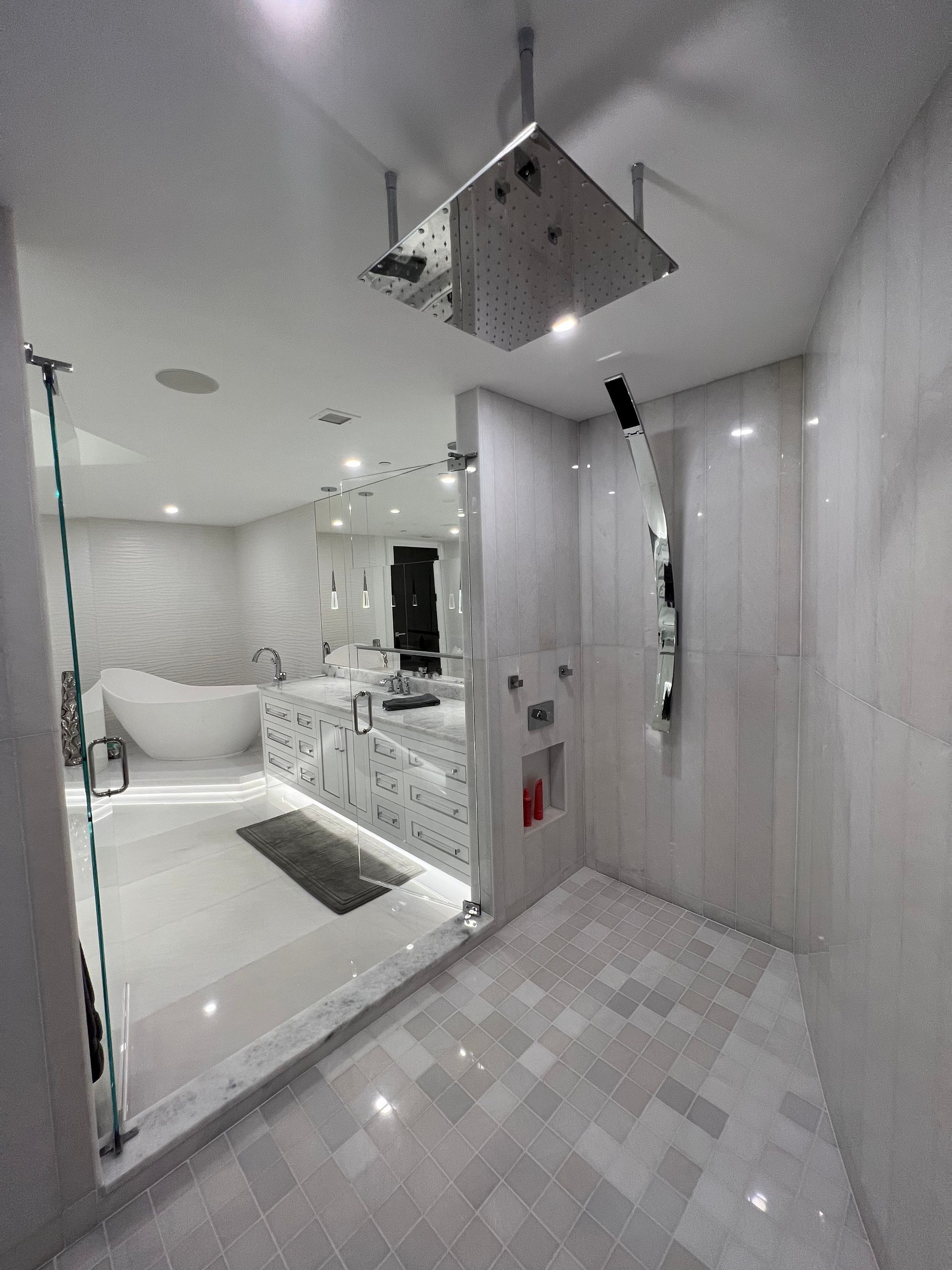 Luxurious bathroom with large shower, soaking tub, and marble accents.