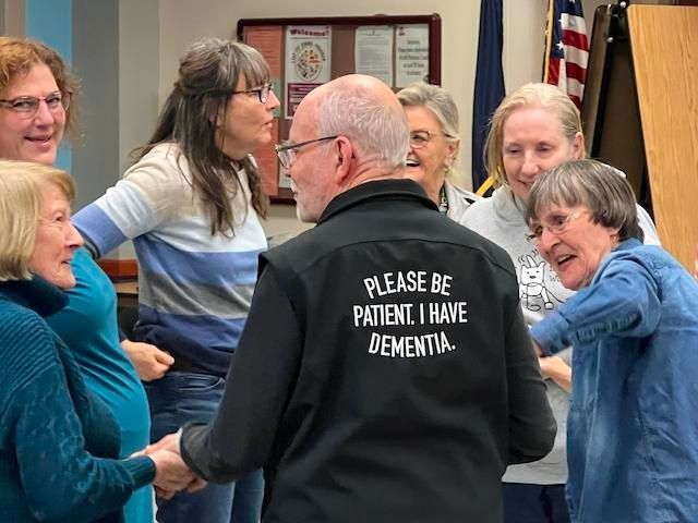 Group of people in a circle, man with 