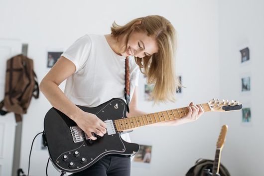 woman playing an electric guitar