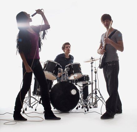 three people in a band playing music