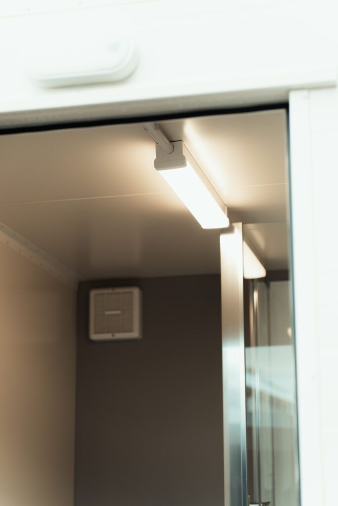 A room with a sliding glass door and a light on the ceiling