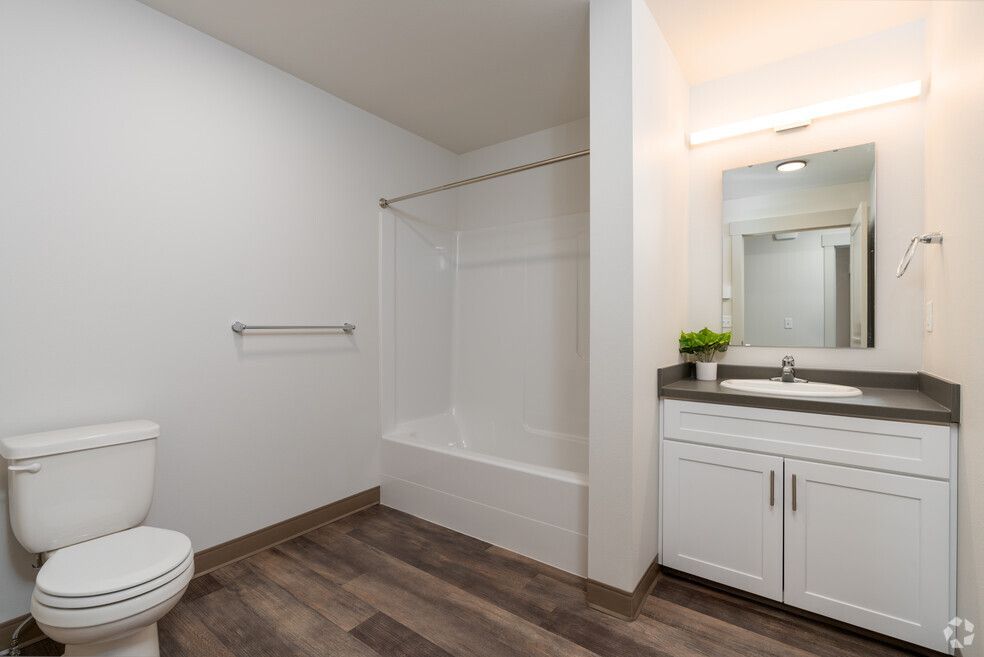 A bathroom with a toilet , sink , and bathtub.