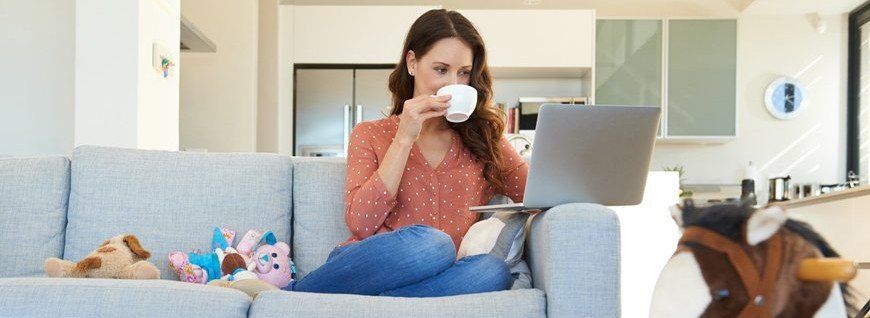 Girl drinking coffee on her computer