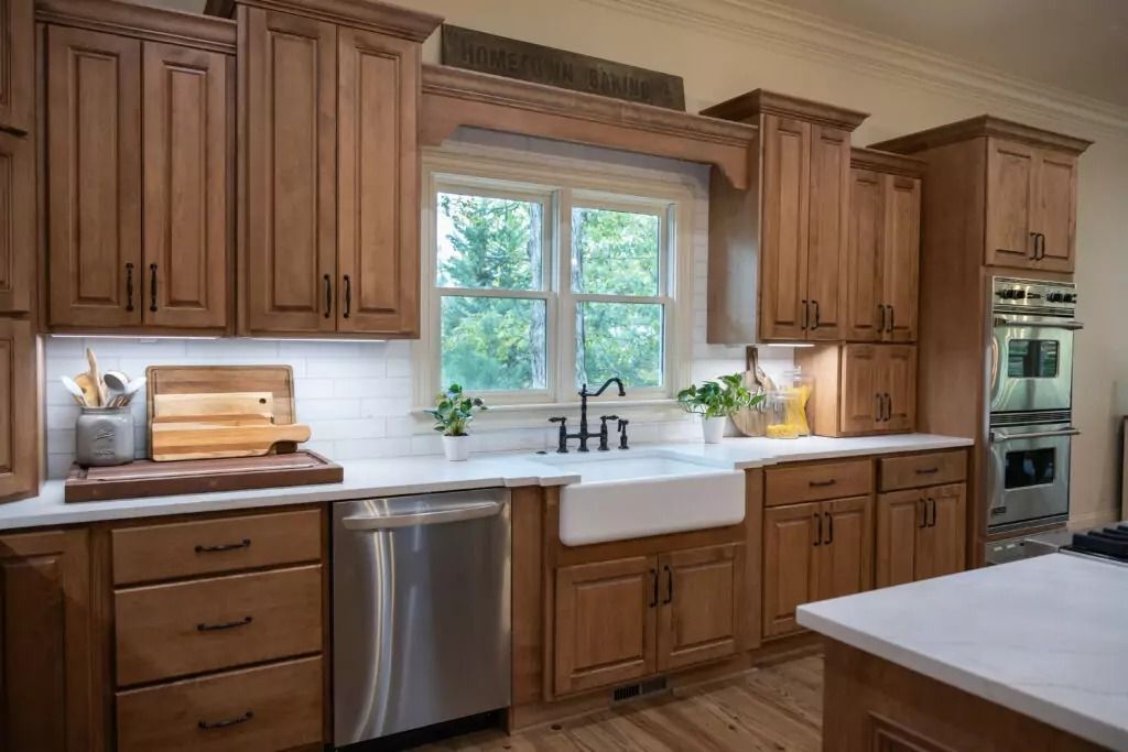 Kitchen with wood cabinets, stainless steel appliances, and a farmhouse sink.