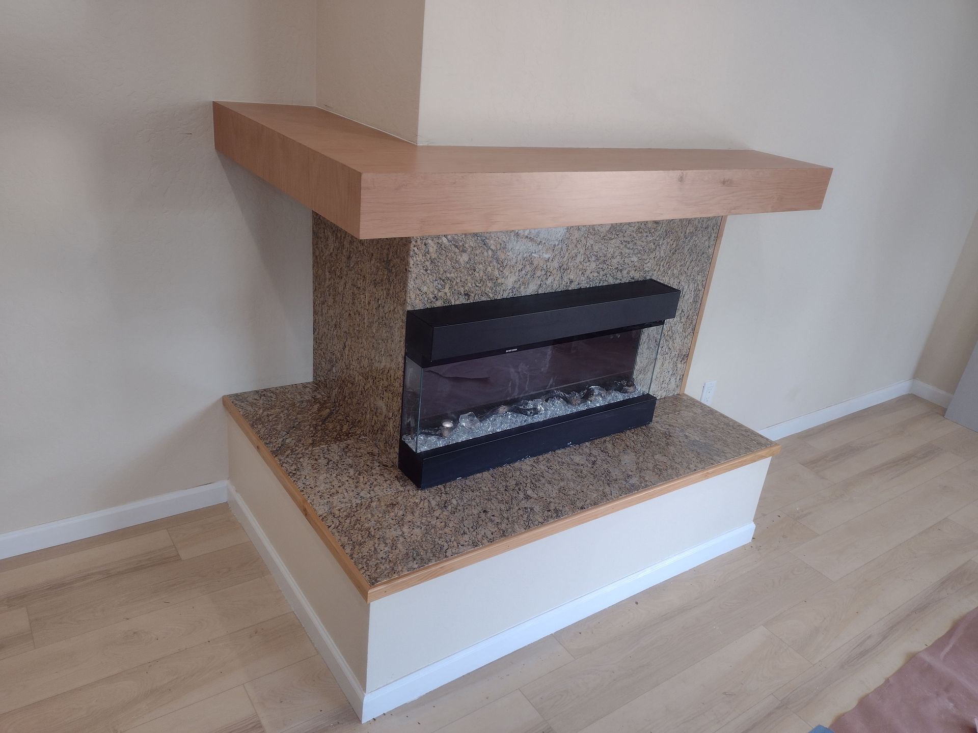 There is a fireplace in the corner of the room.