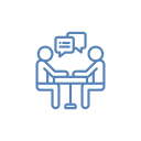 Two stick figures sitting at a table, conversing with speech bubbles above them. Blue line art.