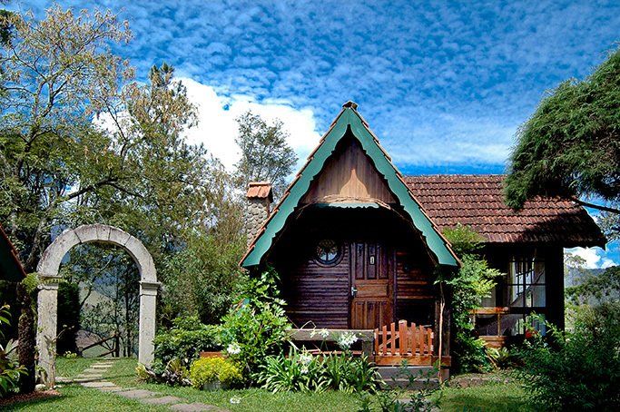 Uma pequena casa de madeira com telhado verde