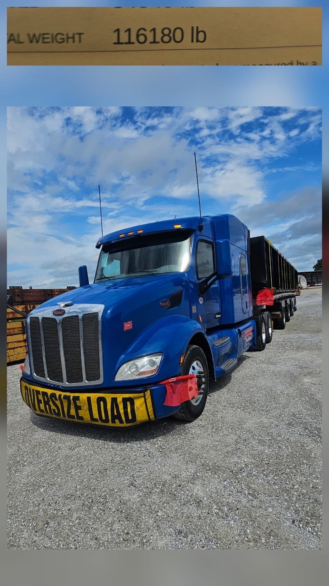 Blue semi-truck carrying tires marked 