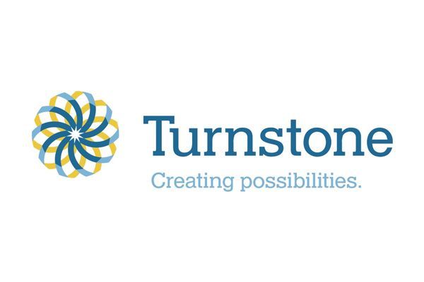 Turnstone logo: abstract flower design in yellow and blue, 