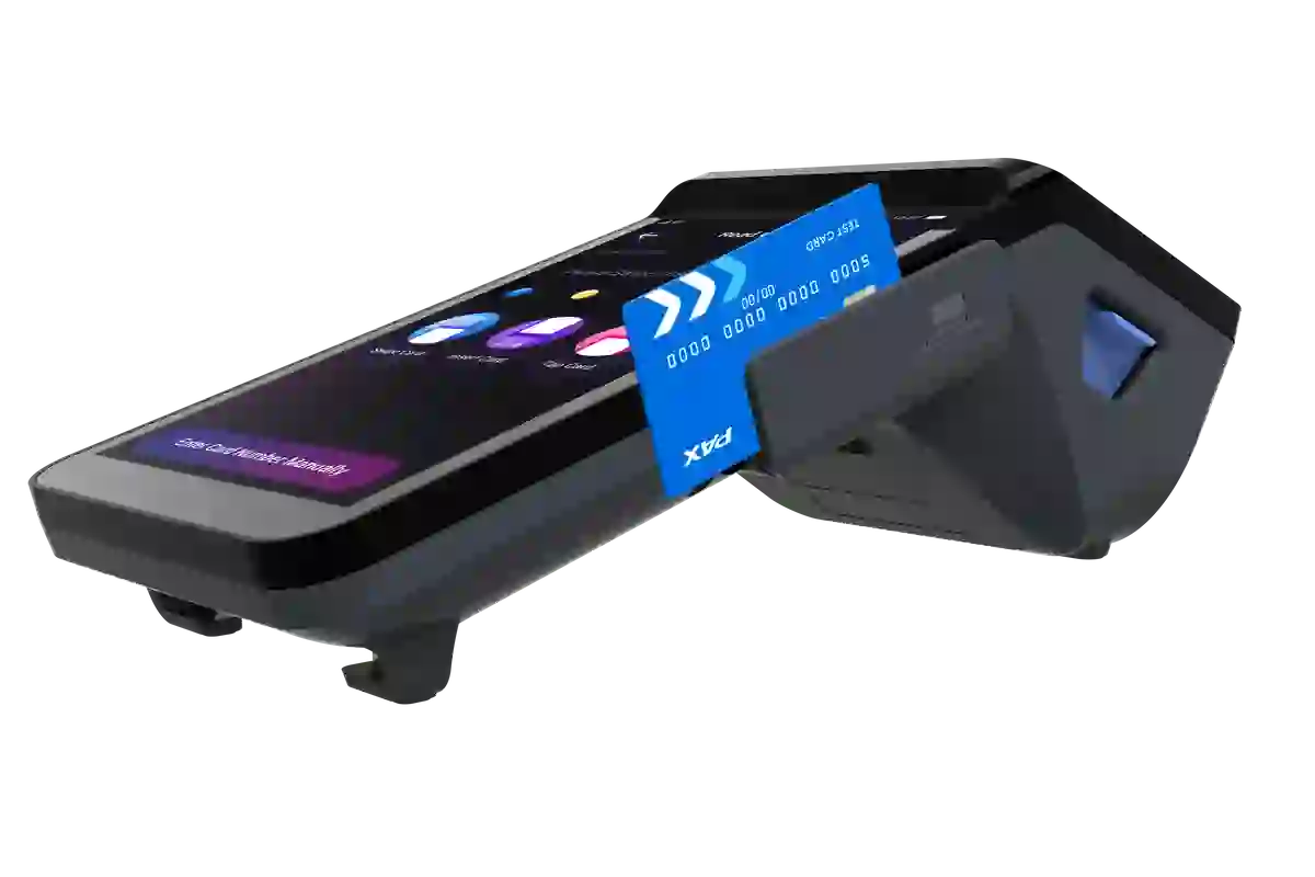 Point-of-sale device with a blue credit card inserted, angled view.
