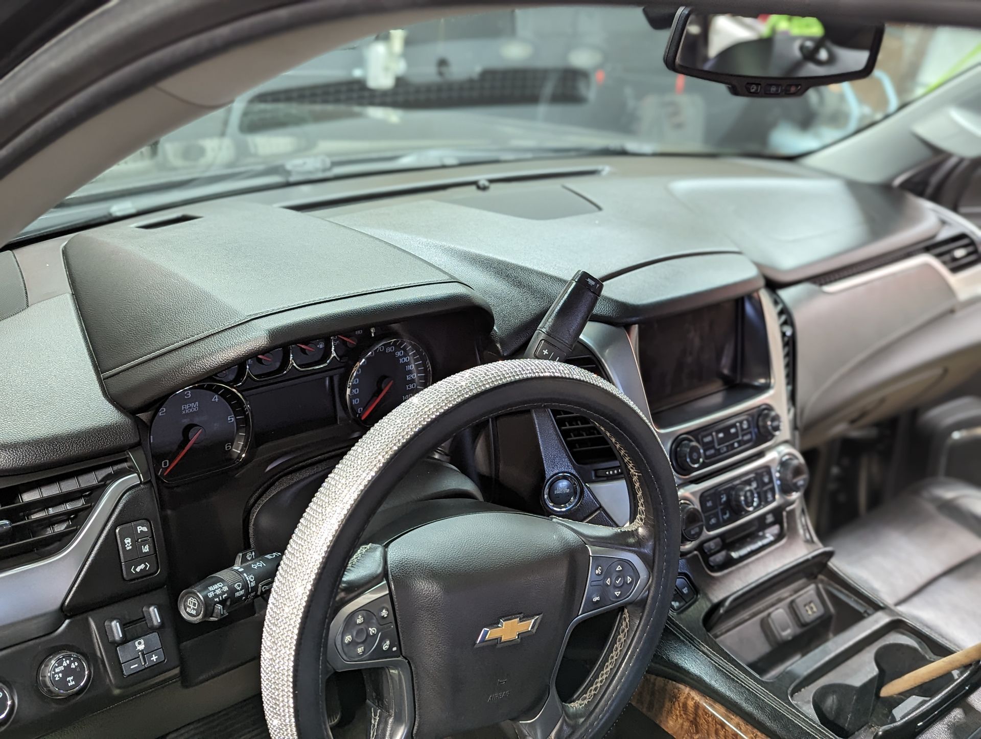 The inside of a car with a steering wheel and dashboard.